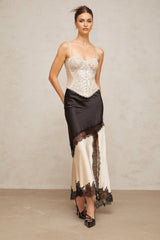 A white bustier top with delicate floral lace paneling visible on the bodice and straps creating an elegant and feminine design