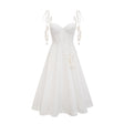 A white corset midi dress with a fitted bodice and flared skirt worn by a model against a plain background