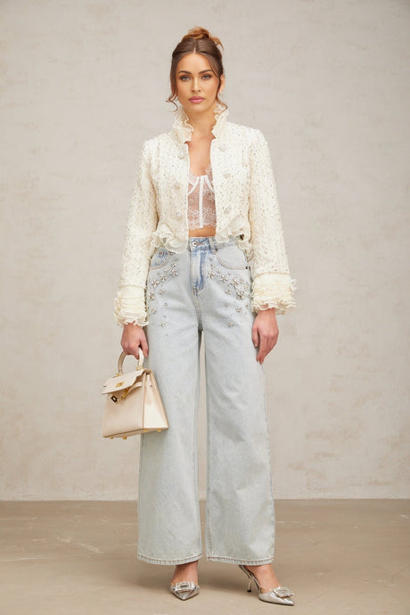 A white cropped jacket with beaded details and ruffle accents named Blanche