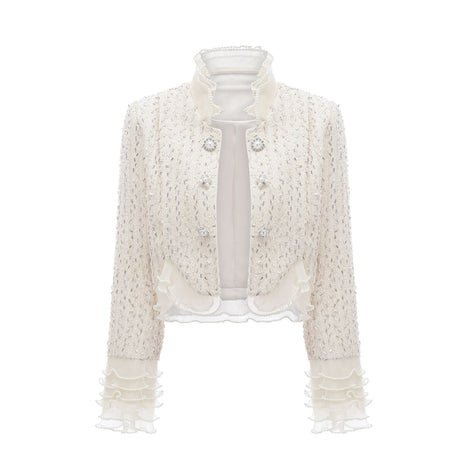 A white cropped jacket with beaded embellishments and ruffle details named Blanche
