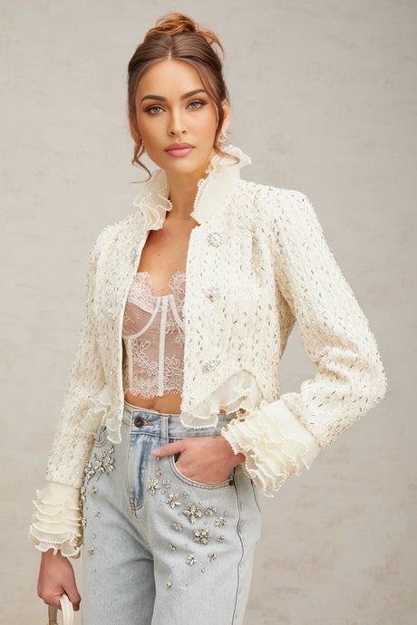 A white cropped jacket with beaded embellishments and ruffle details named Blanche