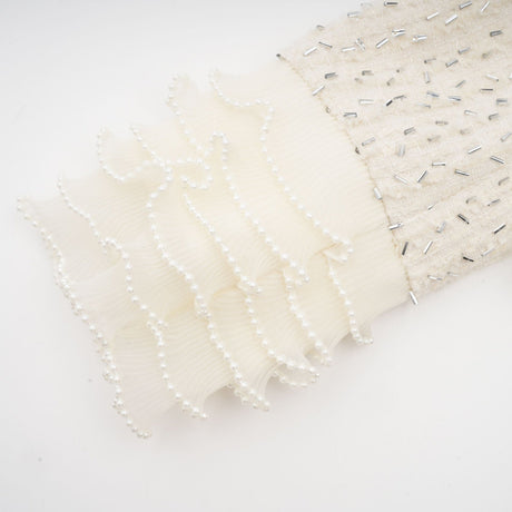 A white cropped jacket with beaded embellishments and ruffle details named Blanche