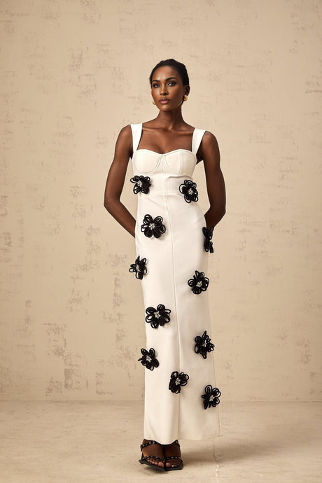 A white floorlength bandage dress with floral applique details named Olivia