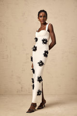 A white floorlength bandage dress with floral applique details named Olivia