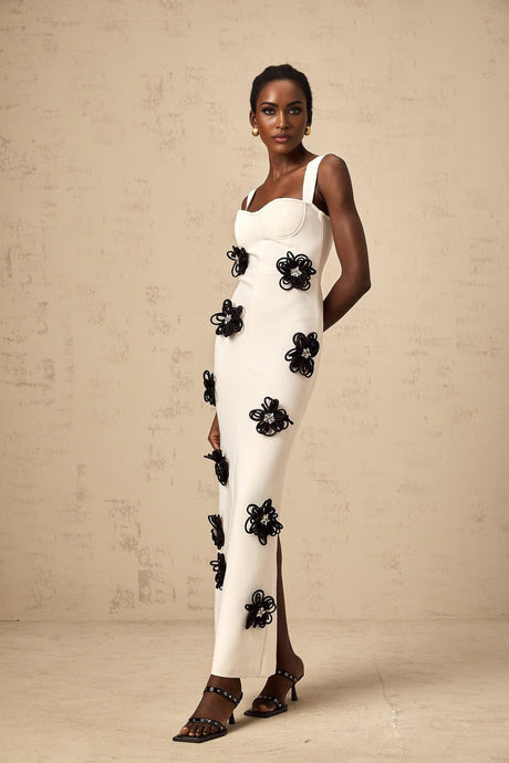 A white floorlength bandage dress with floral applique details named Olivia
