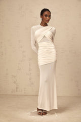 A white floorlength maxi dress with ruched tulle fabric featuring a fitted bodice and flowing skirt