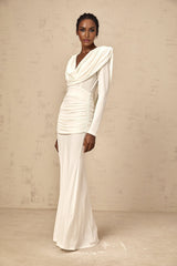 A white fulllength fitted maxi dress with ruched detailing worn by a model named Wanda