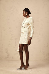 A white furry knit cardigan and matching skirt set worn by a model against a plain background showcasing the Jolanda outfit