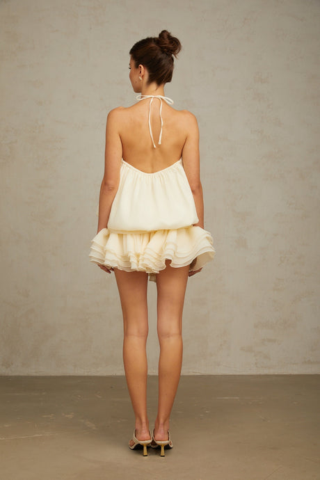 A white halterneck mini dress adorned with faux pearls called Berenice