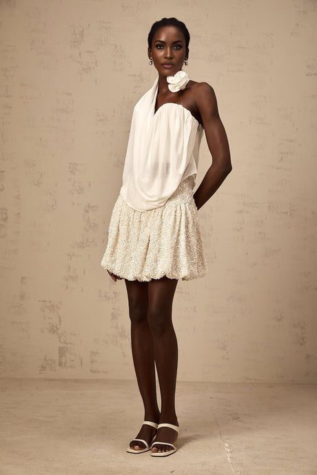 A white halterneck top with floral appliques called Maeva