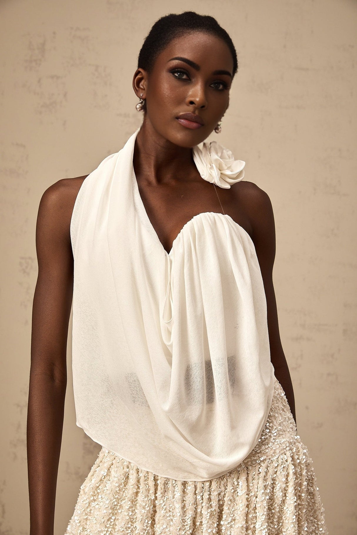 A white halterneck top with floral appliques named Maeva