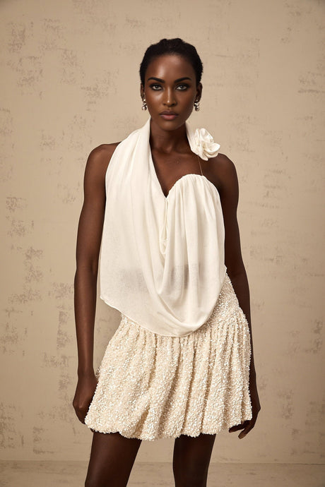 A white halterneck top with floral appliques on it called Maeva