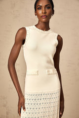 A white knitted maxi dress with faux pearl embellishments