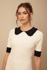 A white knitted mini dress with a split hem design named Andrea