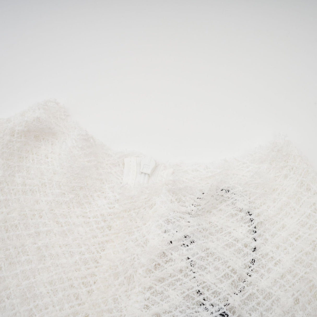 A white lace maxi dress with a wavy pattern featuring long sleeves and a floor length skirt
