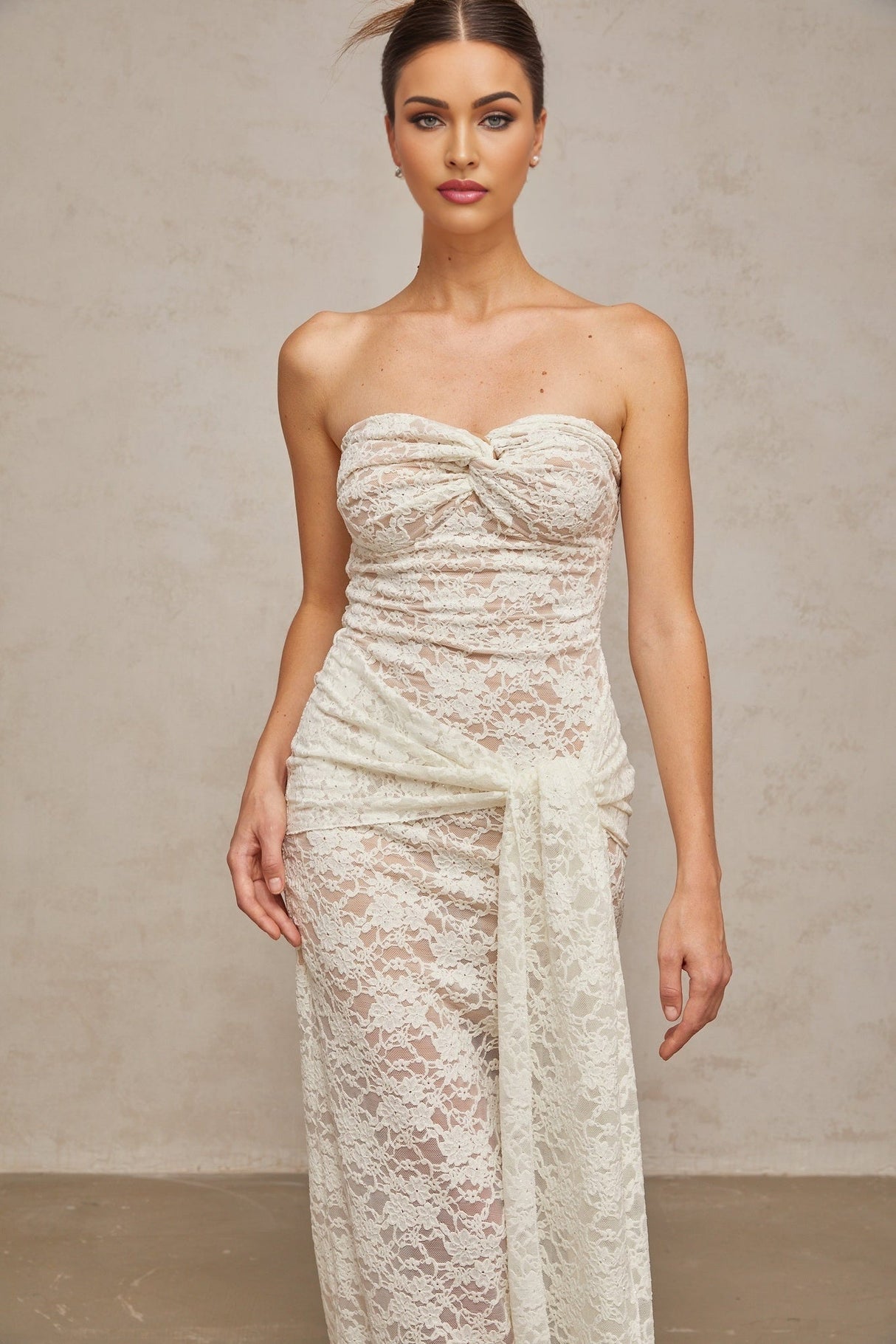 A white lace midi dress with draped detailing named Wilhelmine