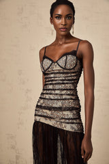 A white lace midi dress with floral embroidery featuring a bustier bodice and ruffled details