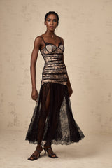 A white lace midi dress with floral embroidery featuring a ruffled bustier top and delicate straps