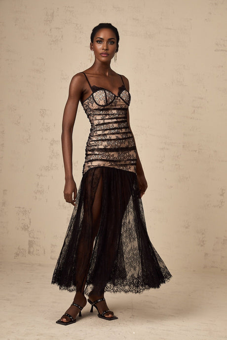A white lace midi dress with floral embroidery featuring a ruffled bustier top and delicate straps