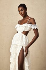 A white lace midi dress with openwork detailing named Genevieve featuring a feminine silhouette and delicate floral patterns throughout the fabric
