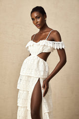 A white lace midi dress with openwork detailing named Genevieve featuring a feminine silhouette and delicate floral patterns throughout the fabric