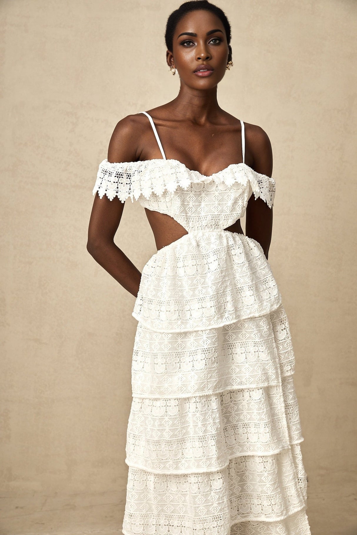 A white lace midi dress with openwork details named Genevieve on a plain background