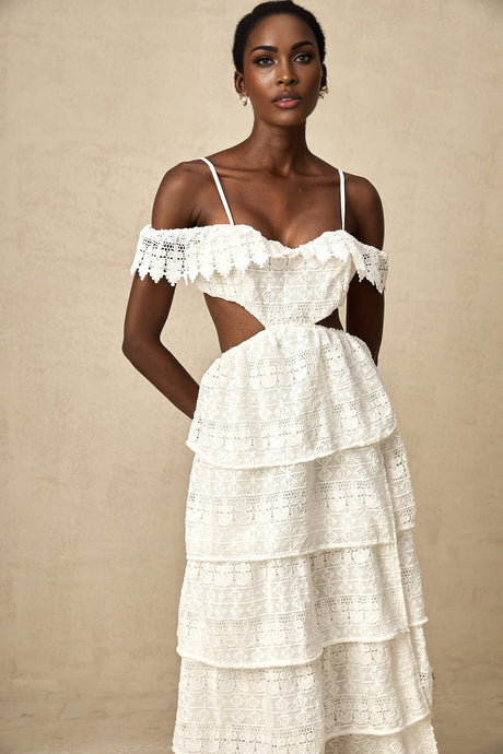 A white lace midi dress with openwork details named Genevieve on a plain background