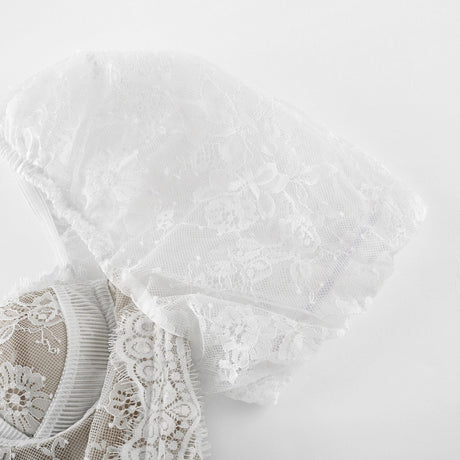 A white lace midi dress with tiered layers by Melisande