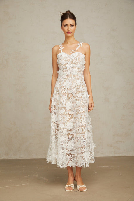 A white lace midi dress with tulle panels named Carole featuring a delicate feminine design with a blend of lace and sheer tulle fabric reaching to mid calf length