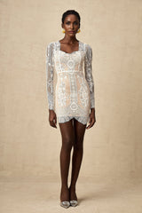 A white lace mini dress with scalloped hem detail and delicate floral pattern
