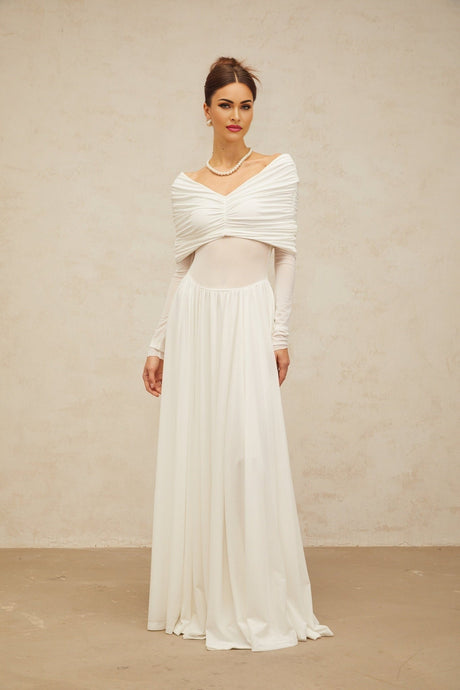 A white long maxi dress with ruched detailing and draped elements on a female model