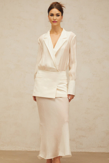 A white long maxi dress with semi sheer panels and a flowing silhouette named Gisele