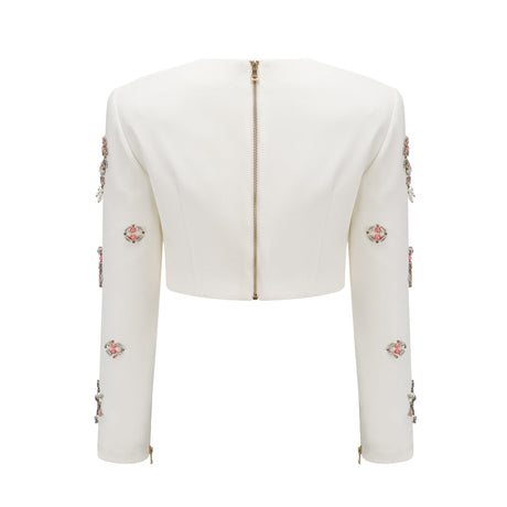 A white matching set consisting of a top and skirt adorned with crystal embellishments named Jeanne The outfit features a sleeveless top and a fitted skirt both decorated with sparkling crystals creating an elegant and sophisticated look