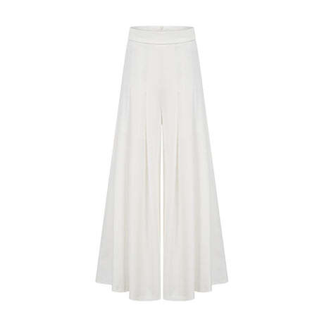 A white matching set featuring a creased top and trousers worn by a model standing against a plain background