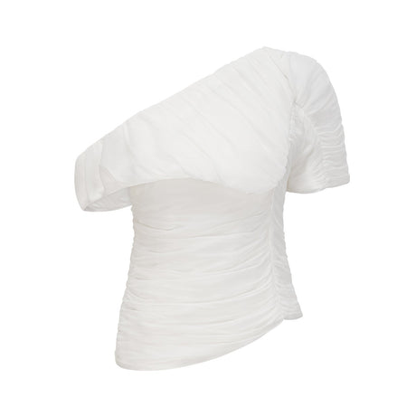 A white matching set featuring a creased top and trousers worn by a model standing against a plain background