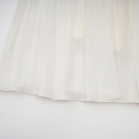 A white matching set featuring a pleated jacket and dress with embellishments The jacket has long sleeves and the dress has a fitted silhouette Both pieces are adorned with delicate embroidery or beadwork creating an elegant ensemble