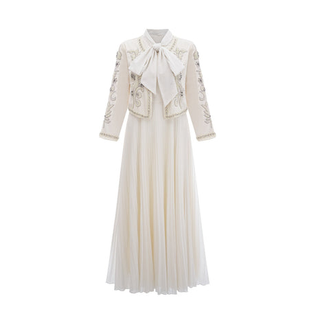 A white matching set featuring a pleated jacket with embellishments and a coordinating dress both in the Blanche style