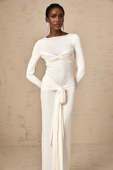 A white maxi dress with ruched fabric and a ribbon twist detail