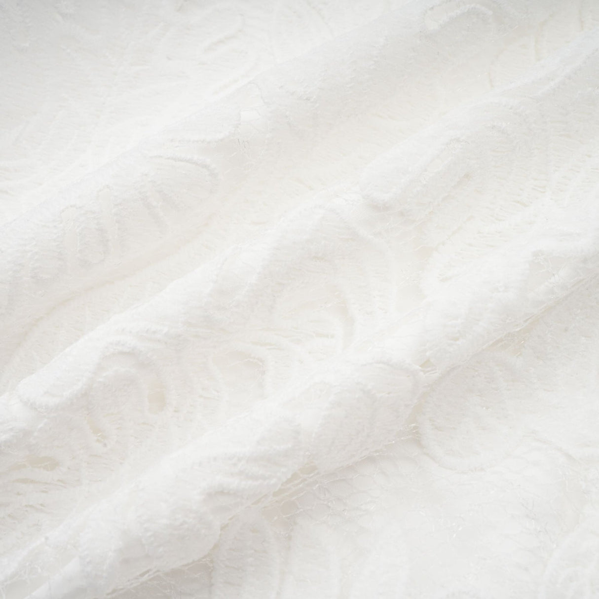A white midi dress featuring panelled design and delicate embroidery details named Madeleine