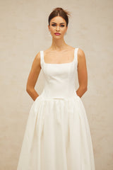 A white midi dress with a bowknot detail and flounce design named Perrine