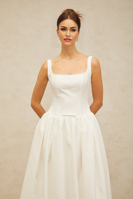 A white midi dress with a bowknot detail and flounce design named Perrine