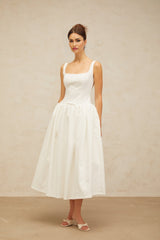 A white midi dress with a bowknot detail and flounce trim featuring a feminine and elegant design