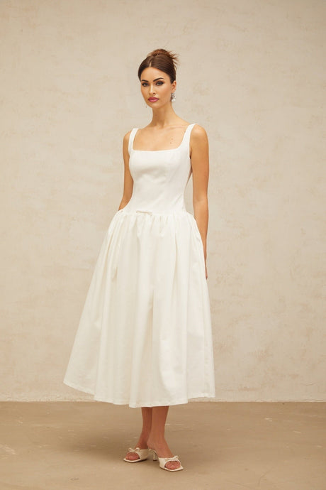 A white midi dress with a bowknot detail and flounce trim featuring a feminine and elegant design