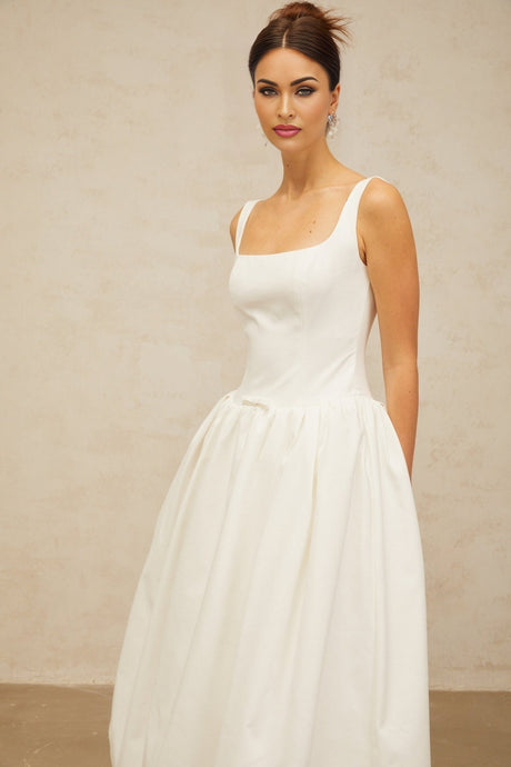 A white midi dress with a bowknot detail and flounced design named Perrine
