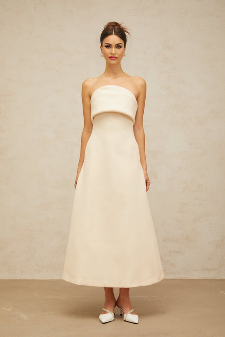 A white midi dress with a folded corset bodice and a fitted silhouette named Raphaelle