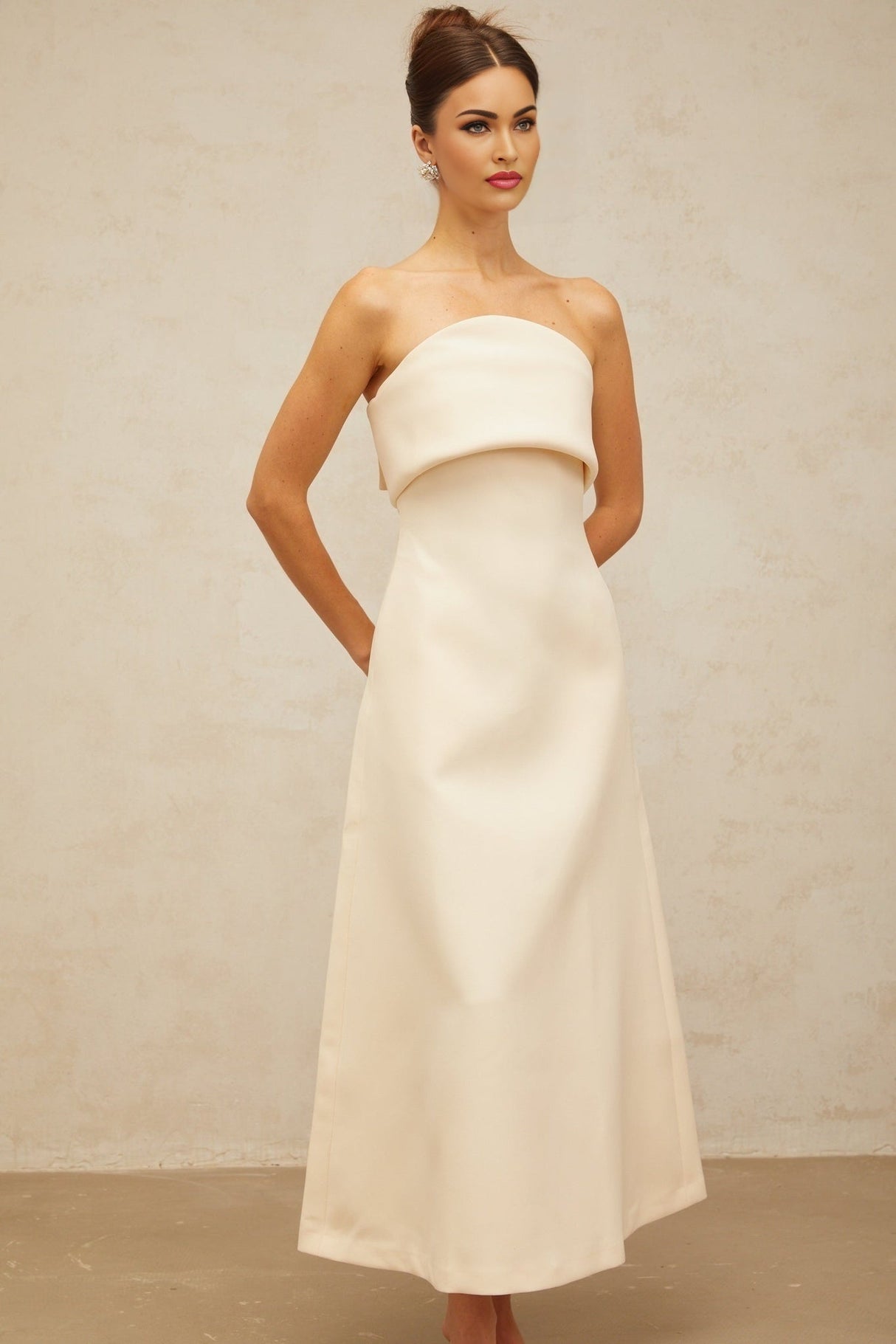 A white midi dress with a folded corset bodice and a fitted silhouette named Raphaelle