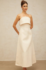 A white midi dress with a folded corset bodice and a fitted silhouette named Raphaelle