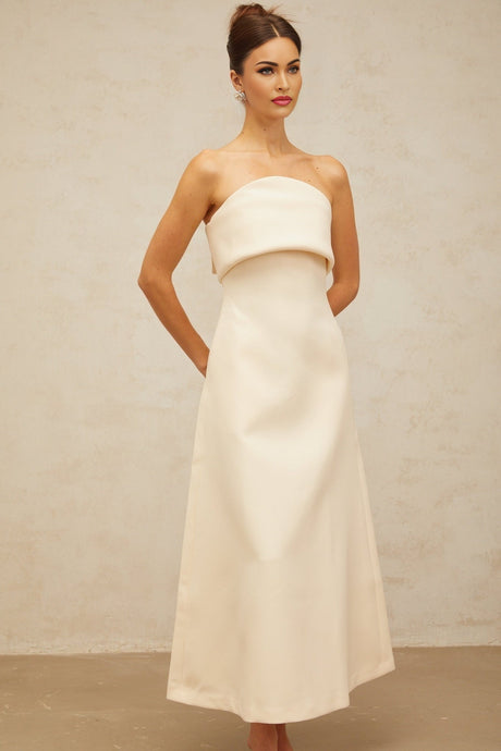 A white midi dress with a folded corset bodice and a fitted silhouette named Raphaelle