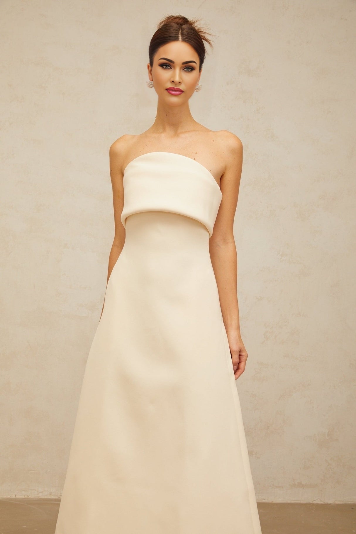 A white midi dress with a folded corset bodice and fitted silhouette named Raphaelle