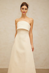 A white midi dress with a folded corset bodice and fitted silhouette named Raphaelle